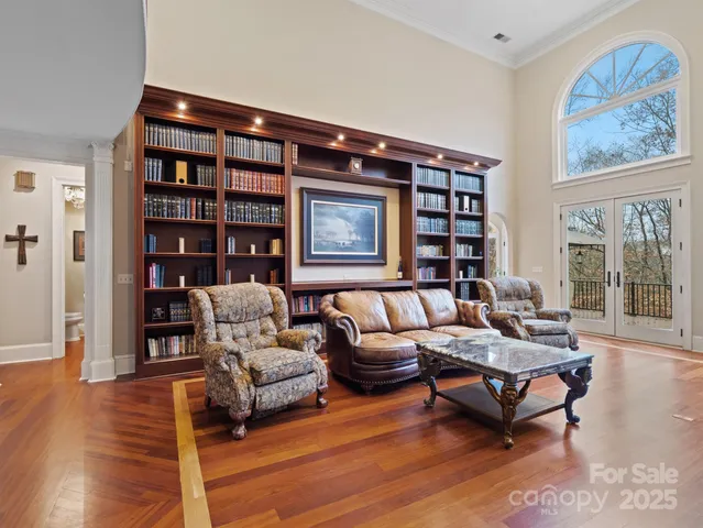 a living room with furniture and a book shelf