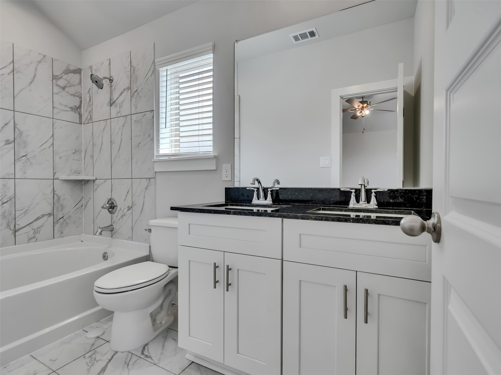 1206 Elsinore Drive Rosharon, TX 77583 - Photo 13 of 21 a bathroom with a bathtub sink vanity mirror and toilet