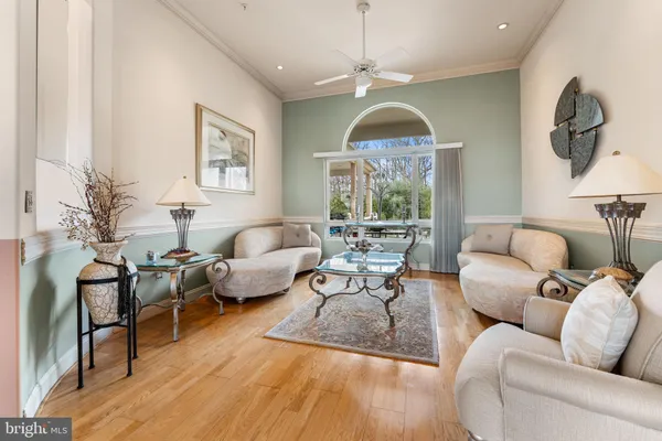 a living room with furniture dining table and a chandelier