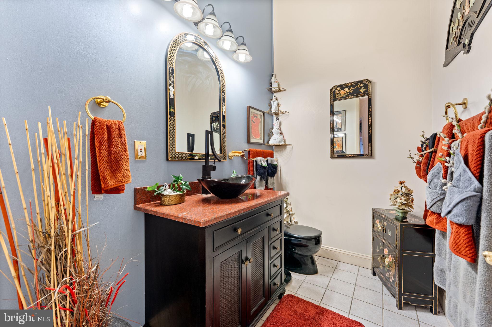 10613 Frank Tippett Road Cheltenham, MD 20623 - Photo 22 of 62 a bathroom with a sink a toilet and a mirror
