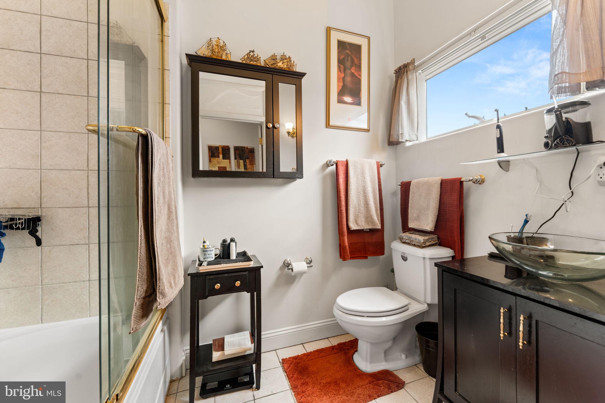 10613 Frank Tippett Road Cheltenham, MD 20623 - Photo 26 of 62 a bathroom with a toilet a sink and mirror