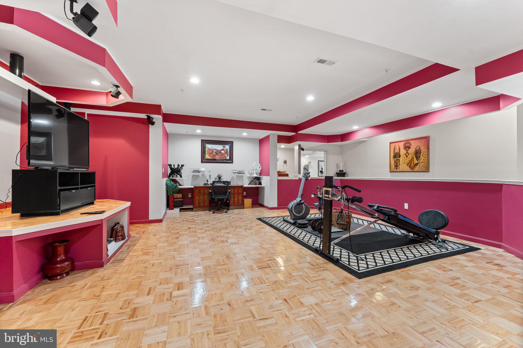 10613 Frank Tippett Road Cheltenham, MD 20623 - Photo 37 of 62 a living room with furniture gym equipment and a flat screen tv