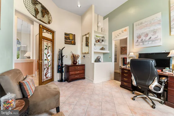a view of a workspace with furniture and a window