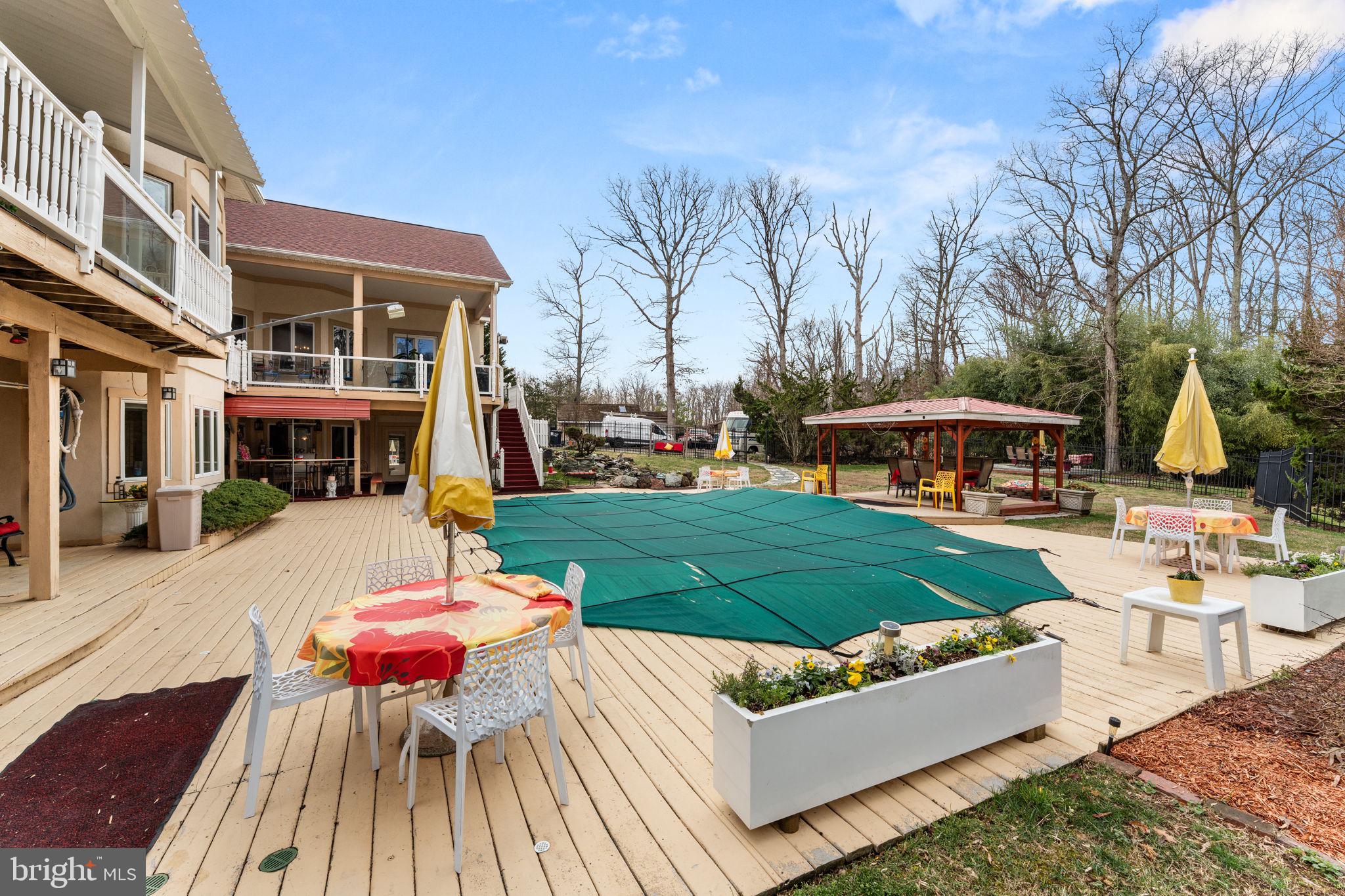 10613 Frank Tippett Road Cheltenham, MD 20623 - Photo 49 of 62 a view of a patio with couches chairs and a fire pit