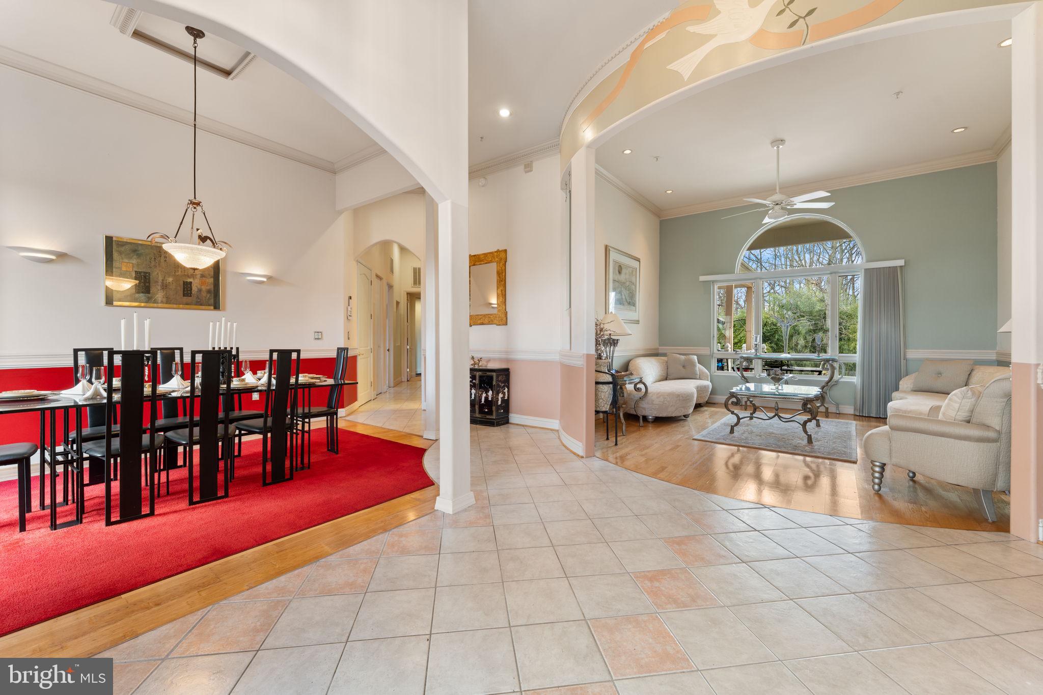 10613 Frank Tippett Road Cheltenham, MD 20623 - Photo 7 of 62 a living room with lots of furniture a dining table and a chandelier