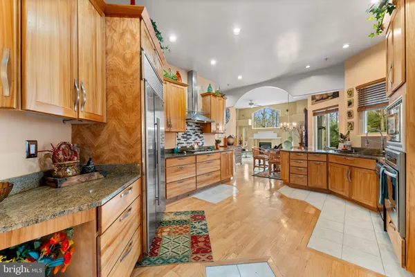 a large kitchen with stainless steel appliances granite countertop a stove and a sink