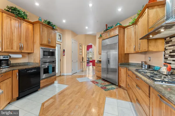 a view of kitchen with granite countertop lots of counter top space