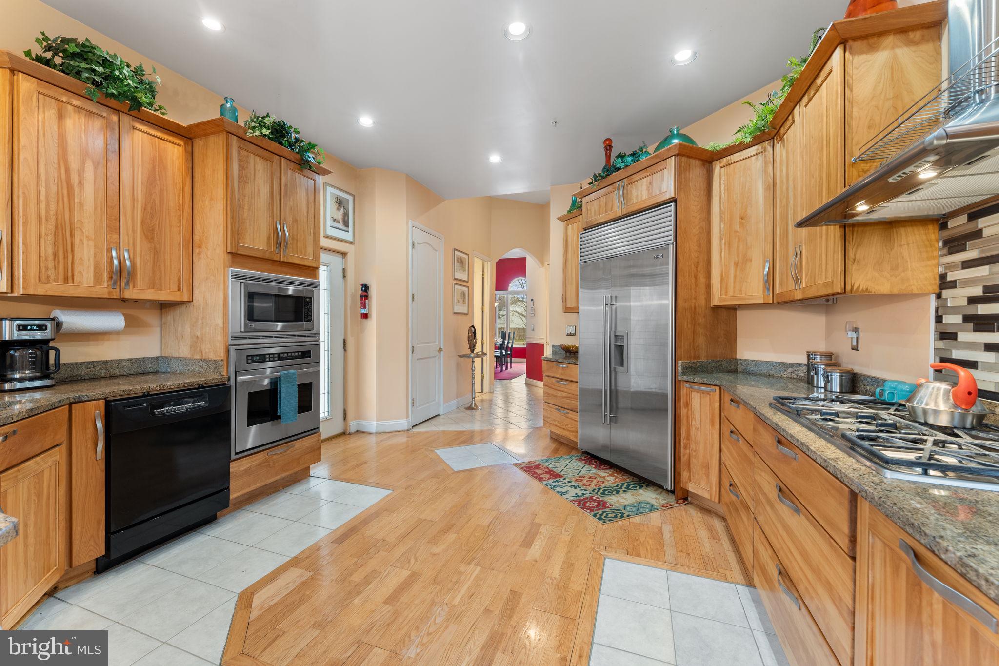 10613 Frank Tippett Road Cheltenham, MD 20623 - Photo 10 of 62 a kitchen with stainless steel appliances granite countertop a refrigerator and a stove top oven