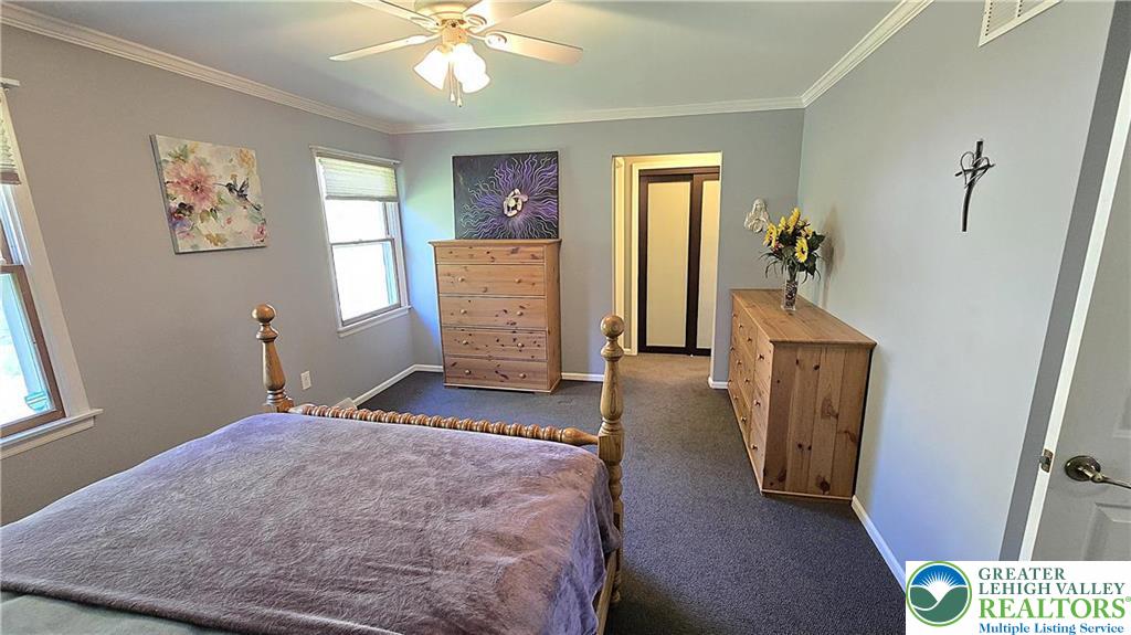 194 Springhouse Road Allentown, PA 18104 - Photo 19 of 34 This cozy bedroom offers a tranquil retreat with soft lighting and ample space for rest.