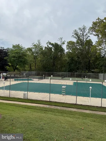 a view of house with outdoor space and trees in the background