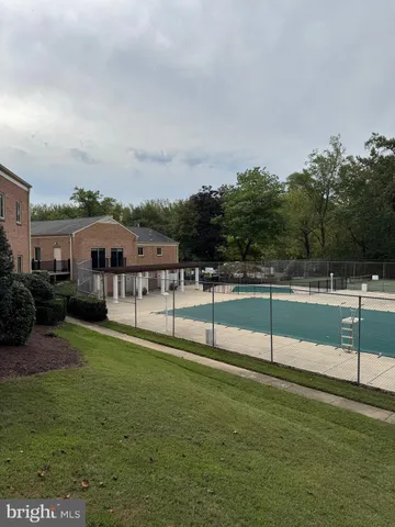a view of yard with swimming pool and seating