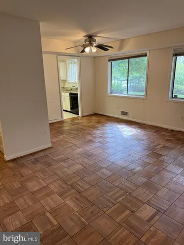 an empty room with windows and a fireplace