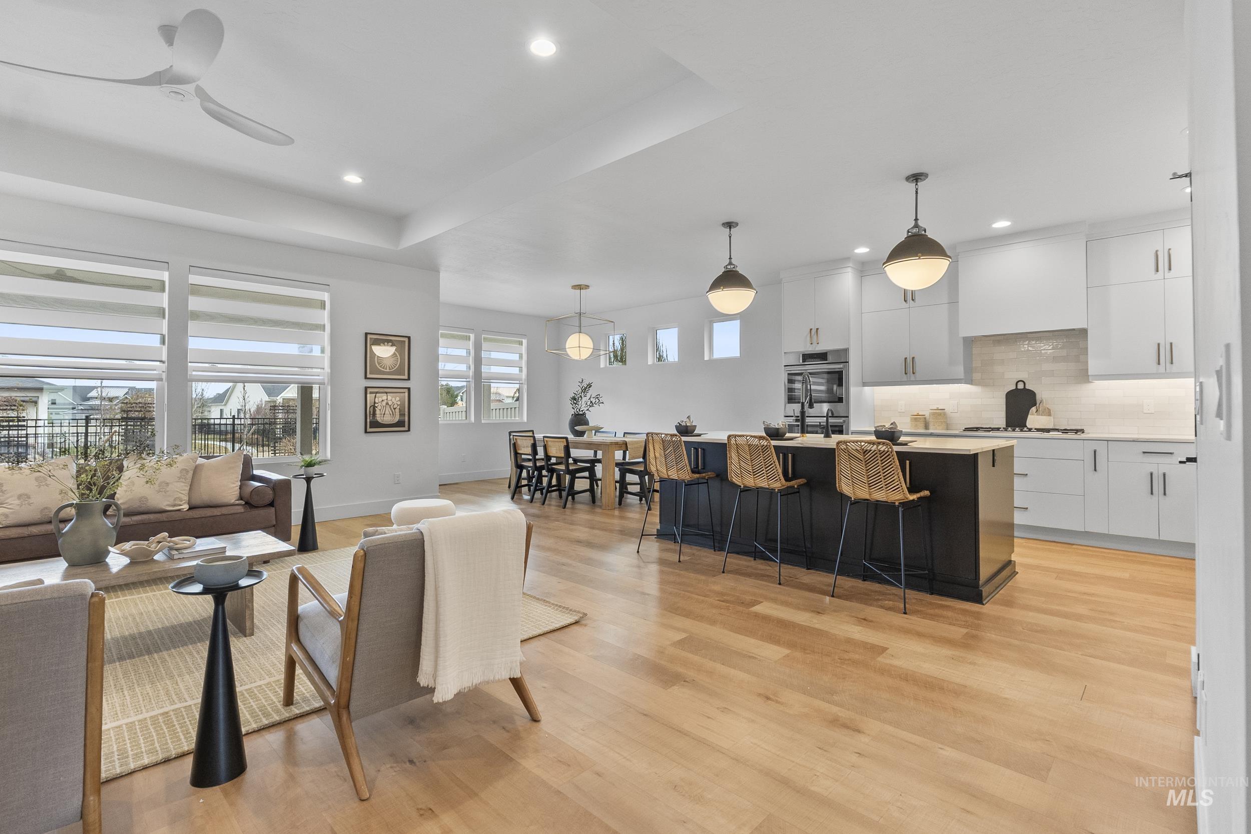 4320 South Selatir Way Meridian, ID 83642 - Photo 13 of 44 Living room with light wood-type flooring, recessed lighting, a raised ceiling, and ceiling fan