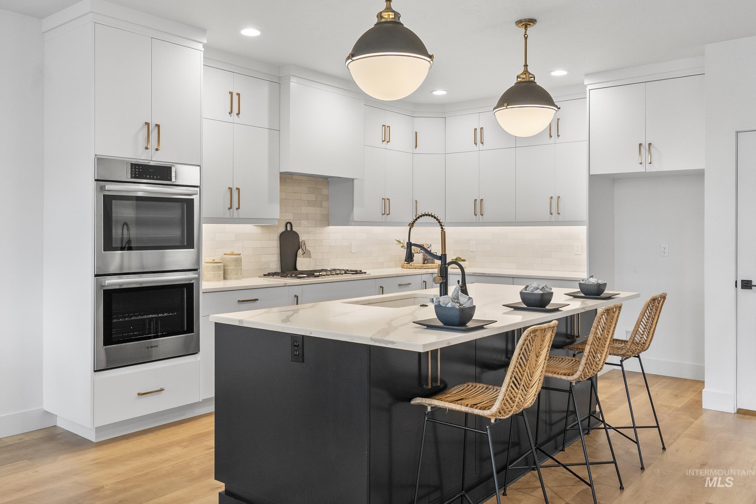 4320 South Selatir Way Meridian, ID 83642 - Photo 14 of 44 Kitchen featuring stainless steel appliances, a center island with sink, white cabinets, light wood-style flooring, and recessed lighting