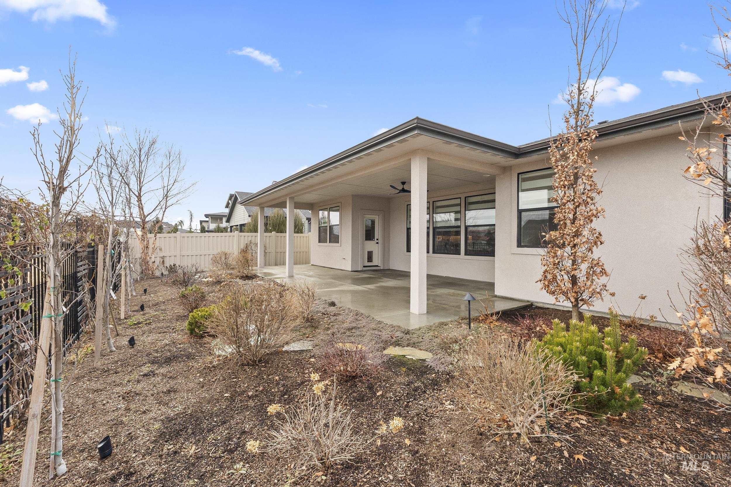 4320 South Selatir Way Meridian, ID 83642 - Photo 42 of 44 Back of property featuring stucco siding, ceiling fan, and a patio area