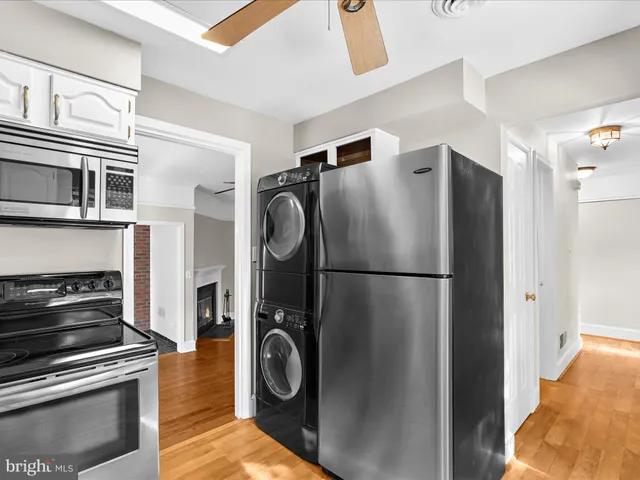 a white refrigerator freezer and a stove sitting inside of a kitchen
