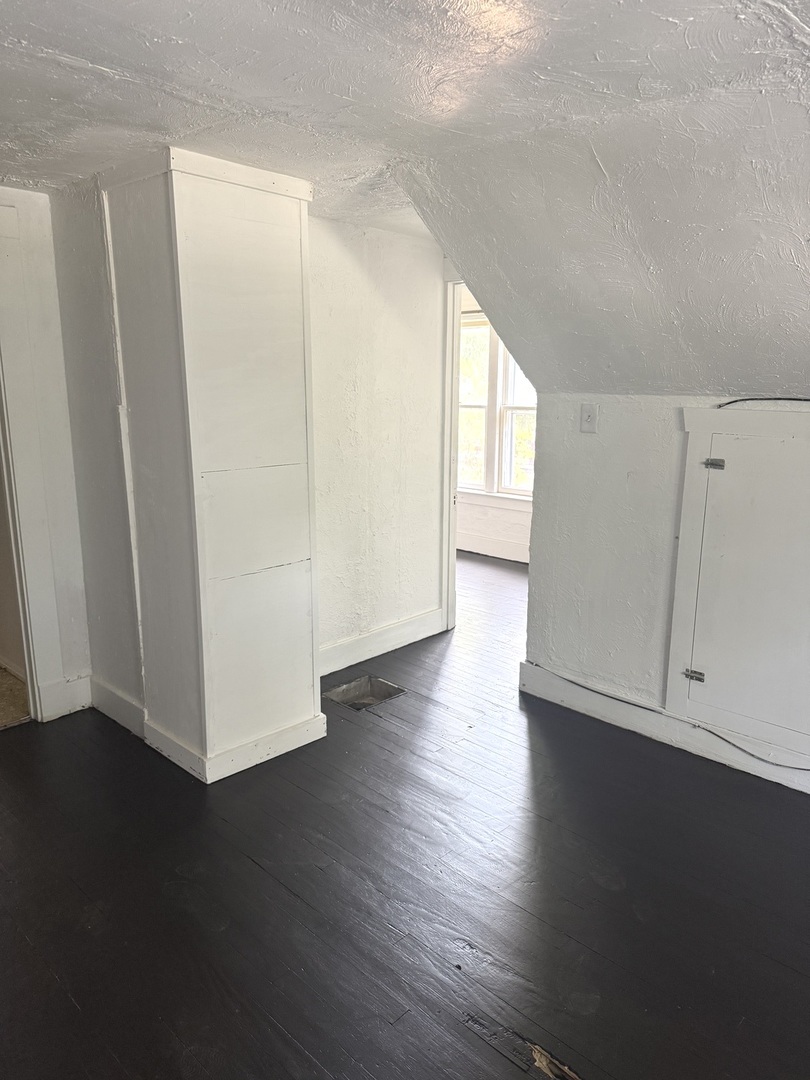 1850 East Prairie Avenue Decatur, IL 62521 - Photo 14 of 16 a view of an empty room with wooden floor and a window