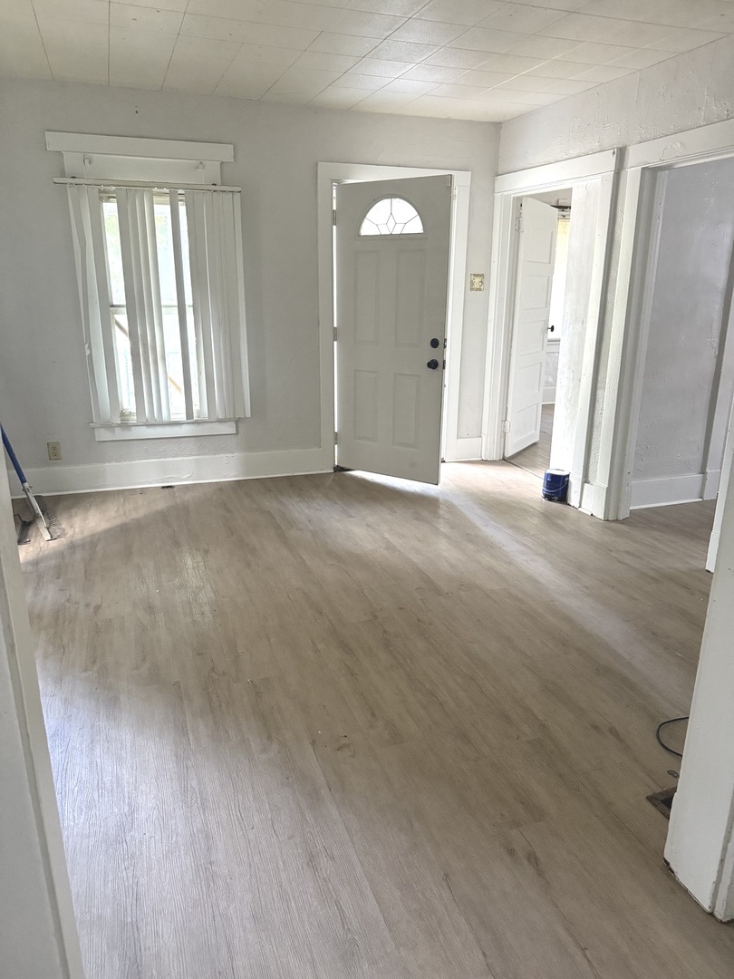 1850 East Prairie Avenue Decatur, IL 62521 - Photo 3 of 16 an empty room with wooden floor and windows