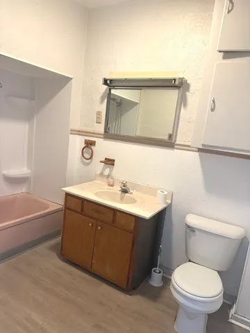 a bathroom with a sink mirror vanity and toilet