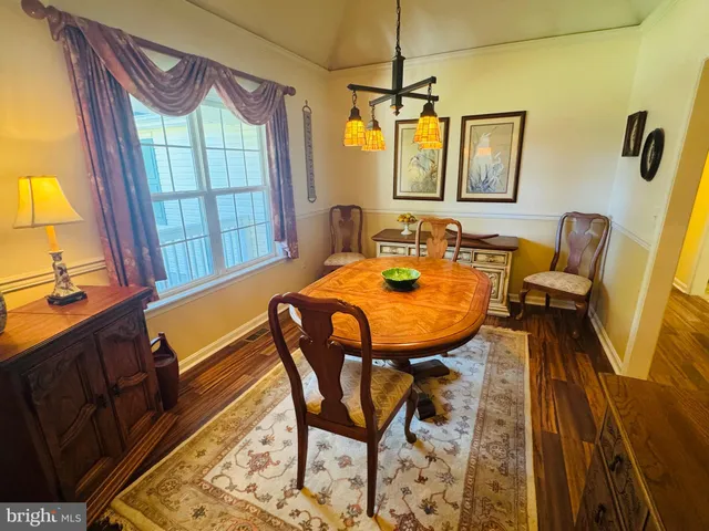 a view of a dining room with furniture and window