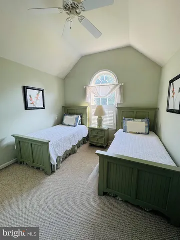 a bedroom with bed and a chandelier
