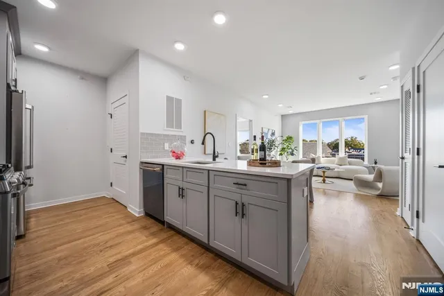 a kitchen with sink refrigerator and cabinets