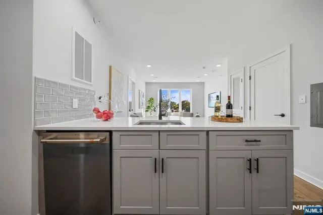 a kitchen with granite countertop white cabinets and white appliances