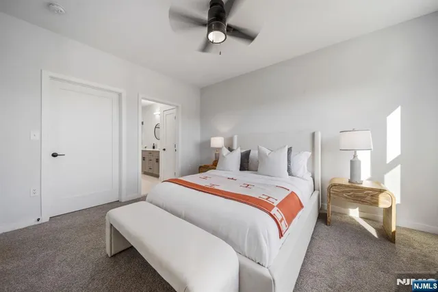 a bedroom with bed and a chandelier