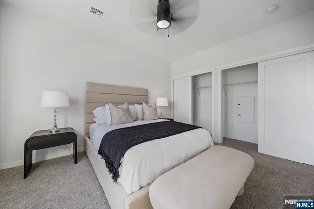 a bedroom with a bed and lamp