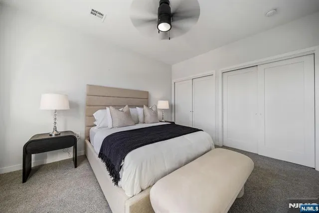 a bedroom with a bed and a lamp