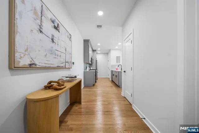 a view of a hallway with wooden floor