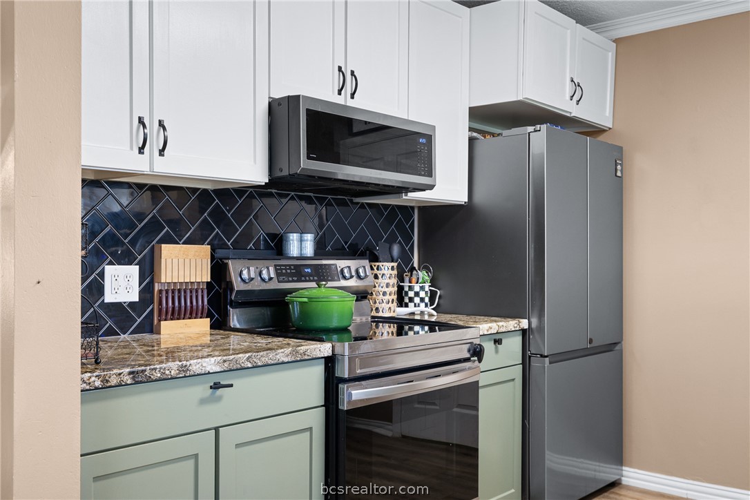 3540 Fisher Ranch Road Bryan, TX 77808 - Photo 10 of 36 a kitchen with stainless steel appliances granite countertop a stove and a microwave
