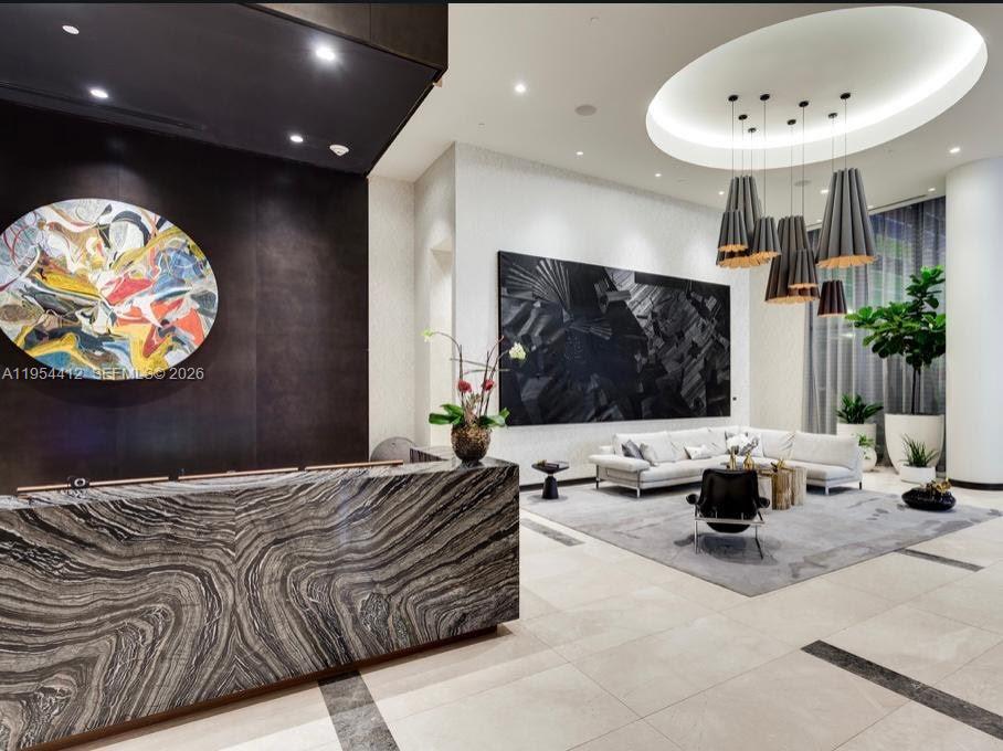 45 Southwest 9th Street, Unit 3910 Miami, FL 33130 - Photo 17 of 27 a bedroom with a bed and a mirror