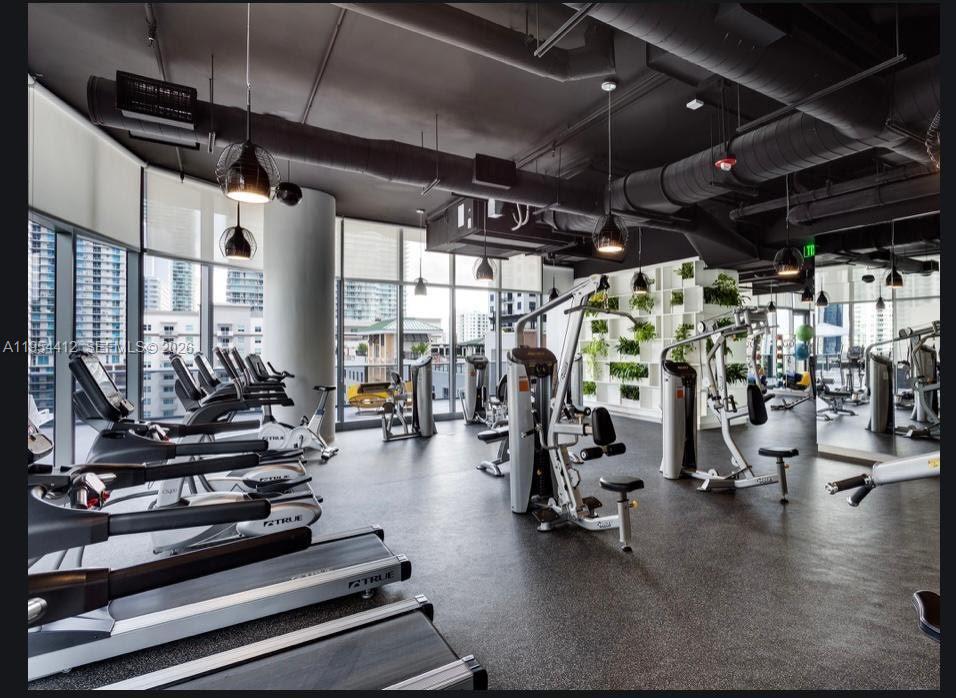 45 Southwest 9th Street, Unit 3910 Miami, FL 33130 - Photo 18 of 27 a view of a room with gym equipment