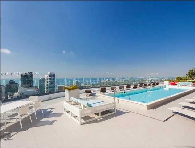 a terrace with outdoor seating and city view