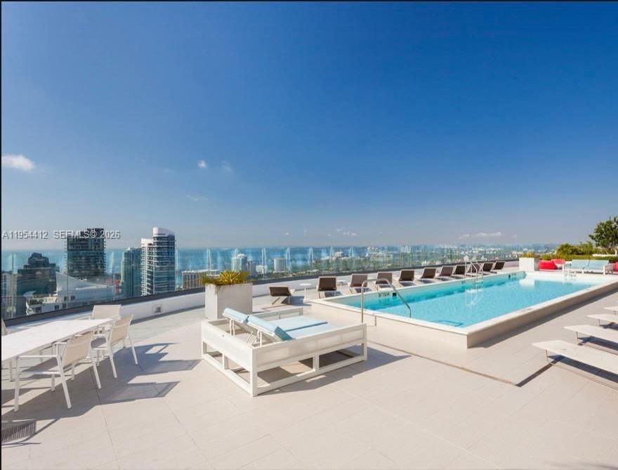 45 Southwest 9th Street, Unit 3910 Miami, FL 33130 - Photo 21 of 27 a terrace with outdoor seating and city view