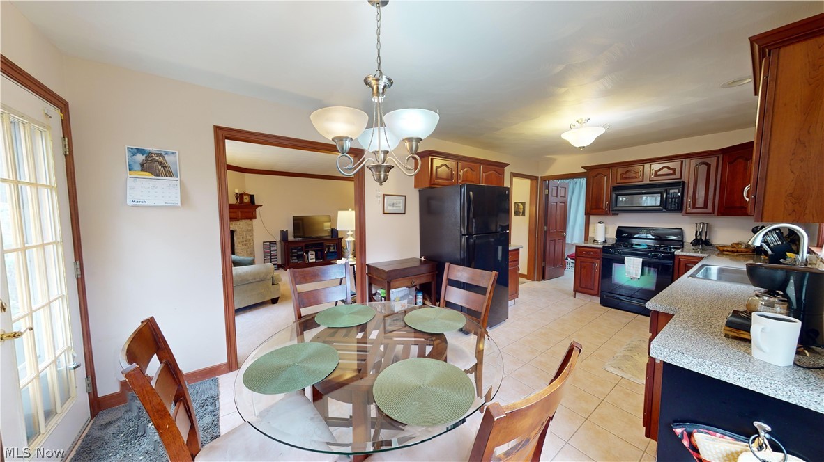 167 Mathews Road, Unit B Youngstown, OH 44512 - Photo 15 of 34 Tiled dining space featuring a chandelier and sink