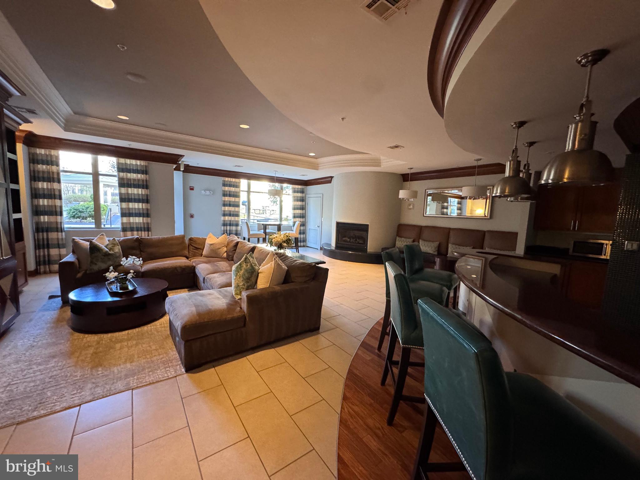 12000 Market Street, Unit 361 Reston, VA 20190 - Photo 48 of 49 a living room with furniture and a flat screen tv