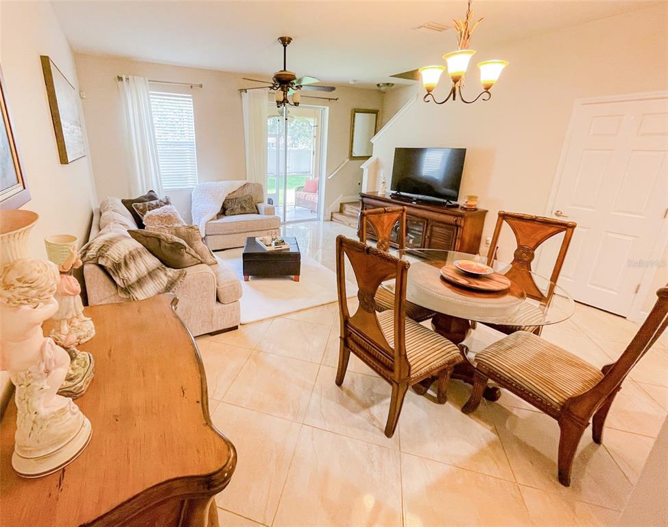 11567 84th St Circle East, Unit 105 Parrish, FL 34219 - Photo 10 of 18 a living room with furniture and a flat screen tv