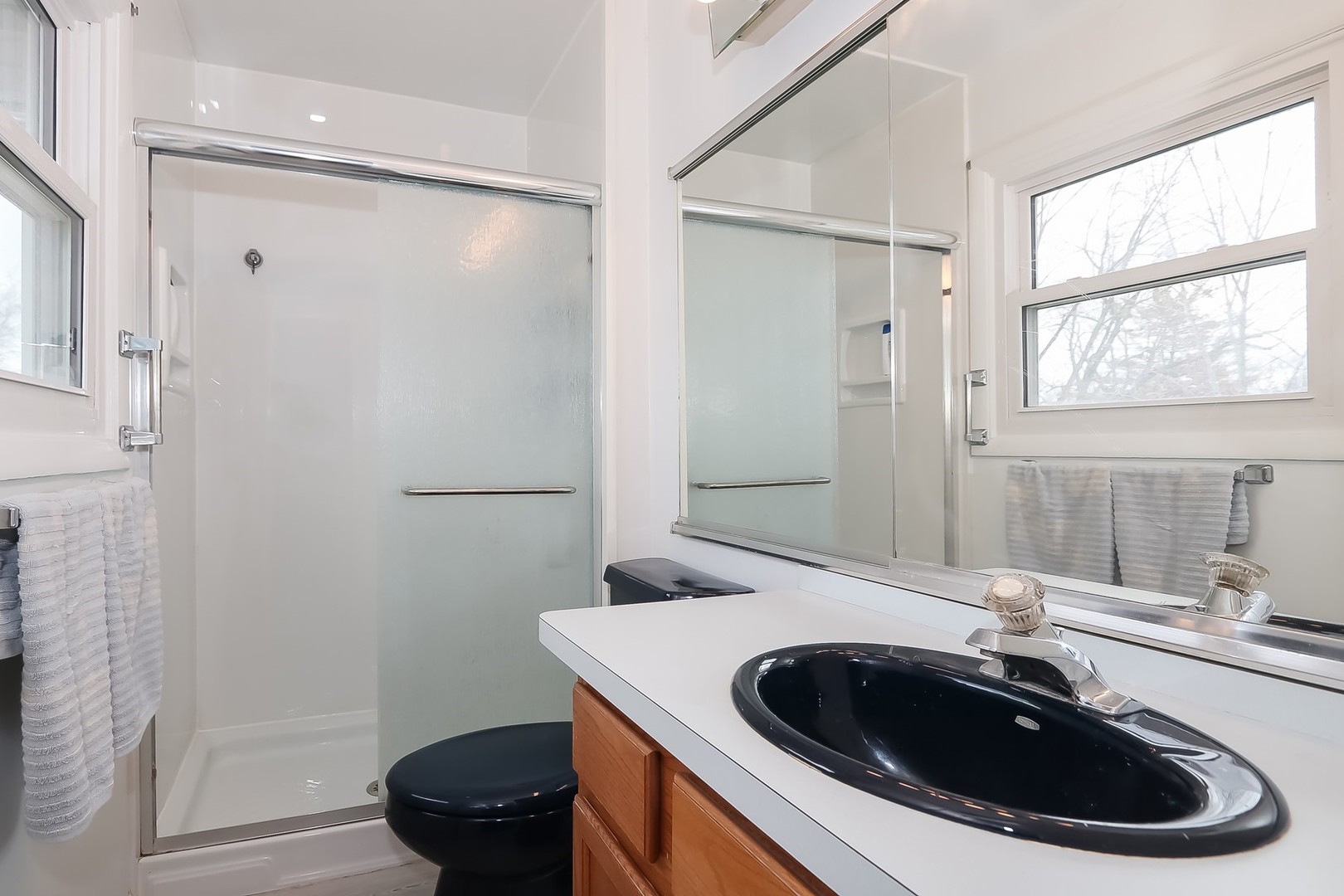993 Bernard Drive Buffalo Grove, IL 60089 - Photo 11 of 29 a bathroom with a sink a toilet and a mirror