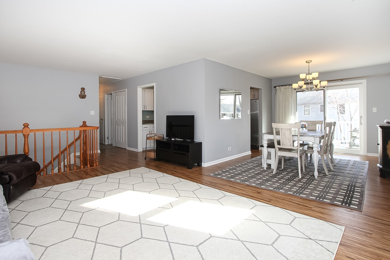 993 Bernard Drive Buffalo Grove, IL 60089 - Photo 2 of 29 a living room with furniture a dining table and a flat screen tv