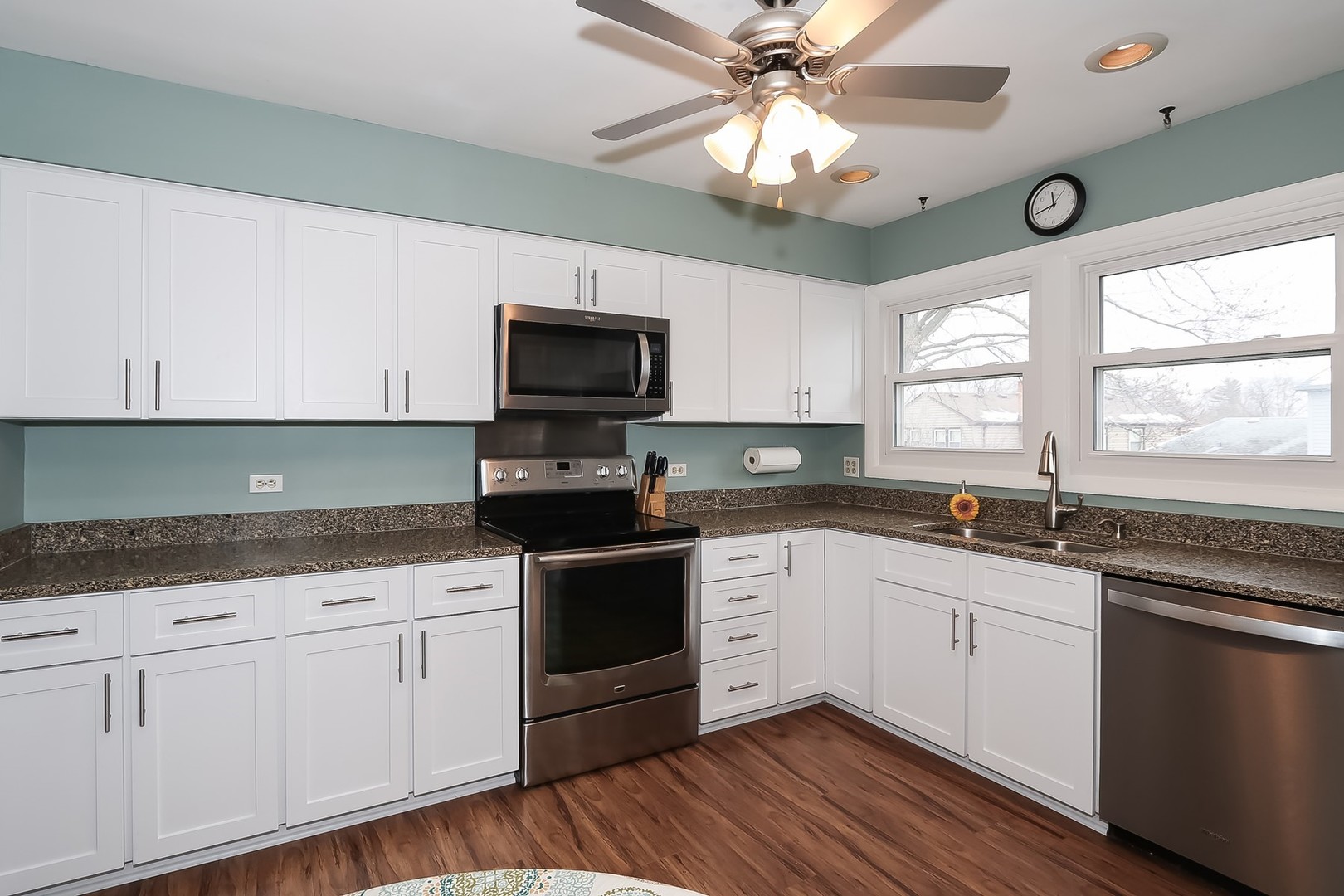 993 Bernard Drive Buffalo Grove, IL 60089 - Photo 6 of 29 a kitchen with stainless steel appliances granite countertop a sink and cabinets