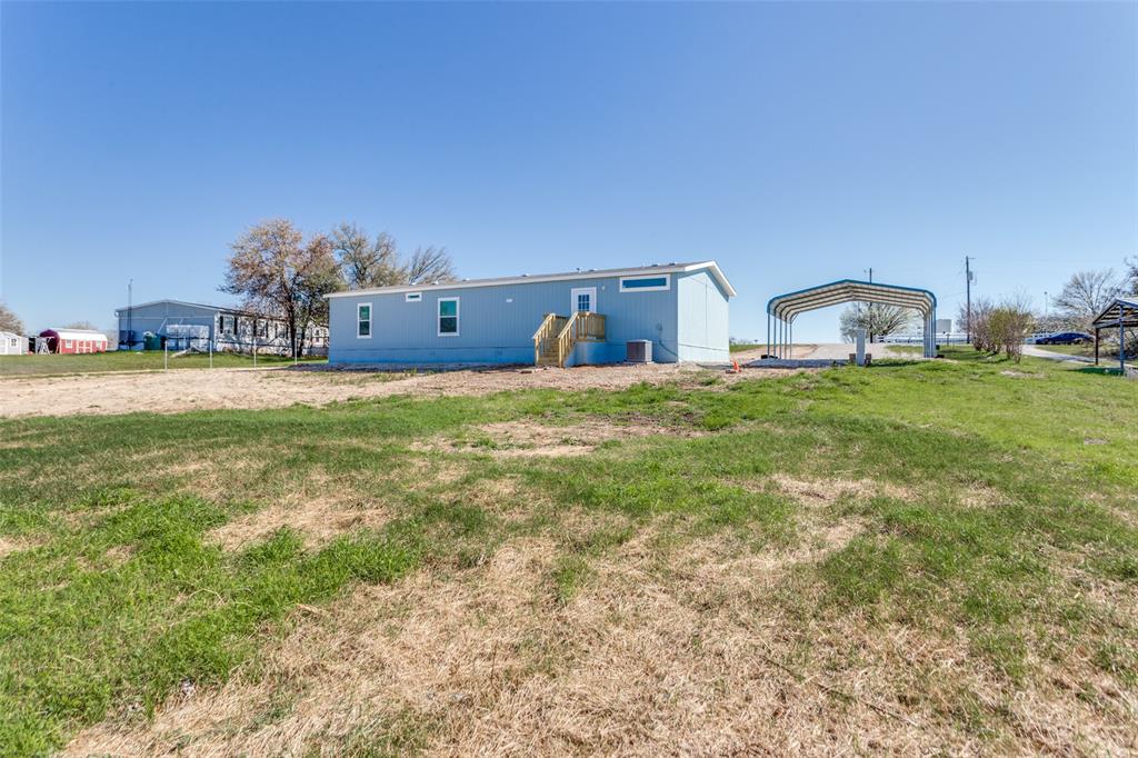 175 Cedar Drive Azle, TX 76020 - Photo 5 of 25 a house with a yard and a large parking space