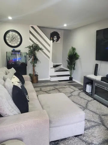 a living room with furniture and a clock