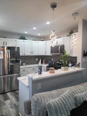 a kitchen with a sink stainless steel appliances and cabinets