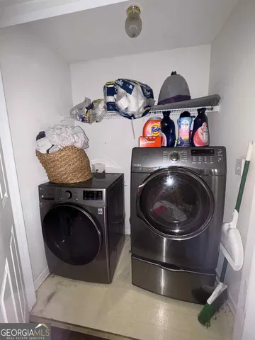 a utility room with dryer washer and other items