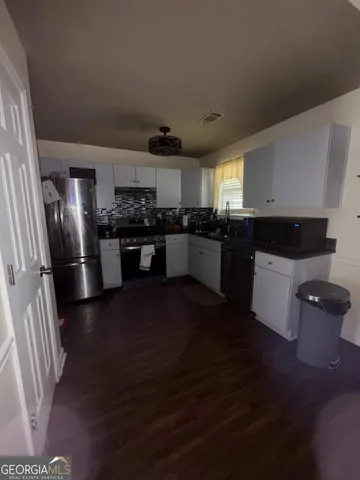 a kitchen with stainless steel appliances granite countertop a stove and a refrigerator