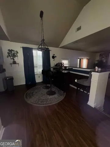 a kitchen with a dining table chairs and a chandelier