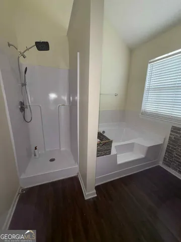 a bathroom with a bathtub and a shower