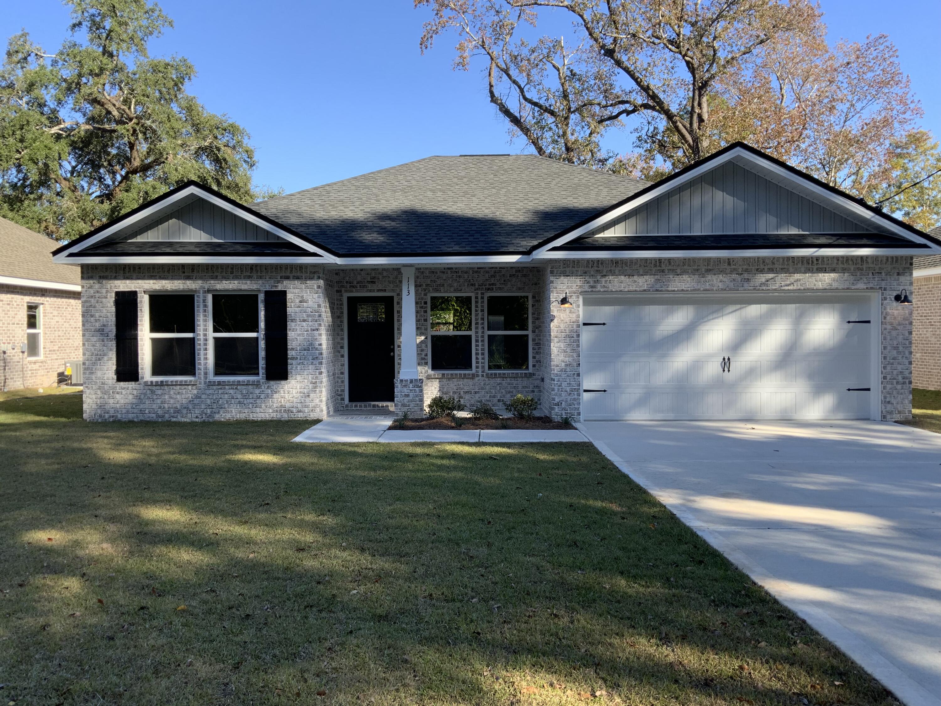 113 Shady Lane Crestview, FL 32536 - Photo 2 of 8 a front view of a house with a garden
